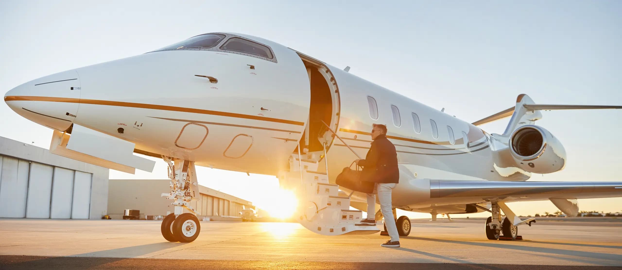 Business jet on tarmac with golden sunset
